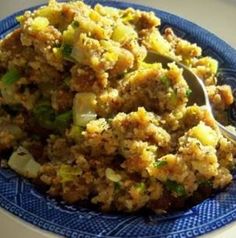 a blue plate topped with food and a spoon