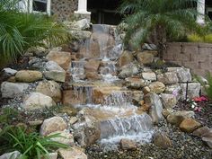 a water fall in front of a house