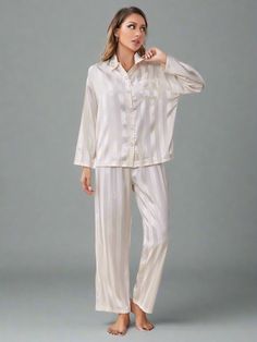 Melody Silk Stripe Button-Up Shirt & Pants Pajama Set. On-trend quality sleep and loungewear made for comfort, style and travel. FEATURES Two-Piece Set Regular Style Long Pants & Long Sleeves Lapel collar and button up front & pocket Pattern: Striped Style: Chic & Modest Material: 97% polyester, 3% elastane CARE GUIDEMachine wash cold. Tumble dry low. SIZING TOP BOTTOM Size Bust Sleeve Length Top Length Shoulder Waist Hip Length S IN 43 18 25 21 25-41 40 39 CM 109 45 63 53 63-104 101 99 M IN 44 18 26 22 27-43 42 39 CM 111 45 66 55 68-109 106 99 L IN 47 18 26 23 29-45 44 40 CM 119 45 66 58 73-114 111 101 XL IN 49 19 27 24 31-47 46 41 CM 124 48 68 60 78-119 116 104 Elegant Pajamas, Quality Sleep, 25 21, Sleep And Loungewear, Pocket Pattern, Swim Shop, Silk Pajamas, Comfort Style, Style Chic