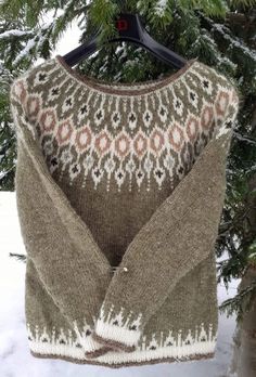 a sweater hanging from a tree in the snow