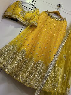 Radiate elegance and grace in our stunning Luminous Yellow Lehenga Choli and Dupatta set. This exquisite ensemble is a treat for any woman who appreciates the beauty of authentic Indian wear. Crafted with perfection in mind, the lehenga choli and dupatta are made from high-quality georgette fabric, ensuring both comfort and style.
The vivacious yellow lehenga features a mesmerizing 3.50 meters flair, which gracefully sways as you move. It is further enhanced by a cancan attachment, adding volume Yellow Lehenga Choli, Georgette Lehenga, Yellow Lehenga, Gray Mirror, Yellow Paper, Dupatta Set, Designer Lehenga Choli, Authentic Indian, Net Dupatta