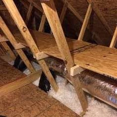 an attic filled with wooden beams and insulation