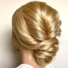 a woman with blonde hair in a bun