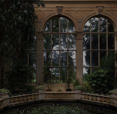 an old building with many windows and plants in it