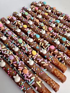 chocolate covered pretzels with sprinkles and candies on white background