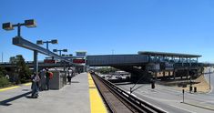 people are waiting at the train station to get on and off the tracks for their next ride