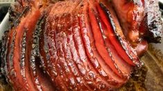 sliced meat sitting on top of a wooden cutting board