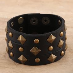 Covered in faceted studs, Indian artisan Deepika Lohani's eye-catching cuff is sure to add some edge to your outfit. Designed for both men and women, the cuff is hand crafted from wide strips of black leather and embellished with brass-plated iron studs. Two row of brass-plated iron snap buttons let you adjust the size to fit your wrist. Studs Indian, Luxurious Things, Mens Cuff Bracelets, Handmade Gifts For Boyfriend, Leather Bracers, Bracelets Black, Leather Jewelry Diy, Mens Cuff, Ankle Jewelry