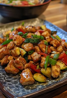 a plate full of chicken and vegetables on a table