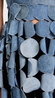 the back of a woman's jean skirt with holes in it