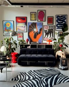 a living room filled with furniture and lots of pictures on the wall above it's couch