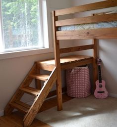 there is a bunk bed with stairs to the bottom and a pink bag under it