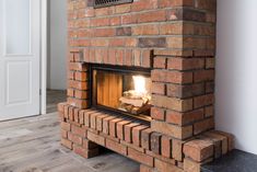 a brick fireplace with a fire in it