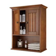 a wooden cabinet with some bottles and towels on it