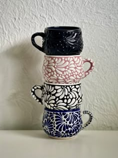 three cups are stacked on top of each other