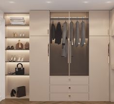 an empty closet with clothes and handbags on the shelves, in front of a white wall