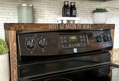 a black stove top oven sitting inside of a kitchen next to a white brick wall