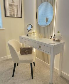 a white chair sitting in front of a desk with a mirror on top of it