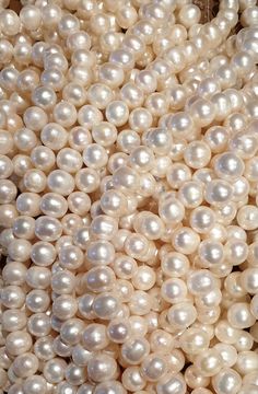 many white pearls are stacked together on the table