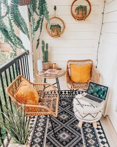 an outdoor patio with wicker furniture and potted plants on the side porch area