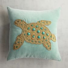 a pillow with a sea turtle embroidered on it