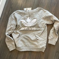 Light Grey Hoodie With White Adidas Logo- Size Medium Crew Neck Hoodie With Logo Print For Spring, Adidas Athleisure Hoodie With Crew Neck, Adidas Casual Sweatshirt For Sports, Athleisure Logo Print Sweatshirt For Spring, Adidas Casual Sports Sweatshirt, Spring Athleisure Sweatshirt With Logo Print, Spring Logo Print Hoodie, Casual Hoodie Tops With Logo Print, Spring Athleisure Sweatshirt With Kangaroo Pocket