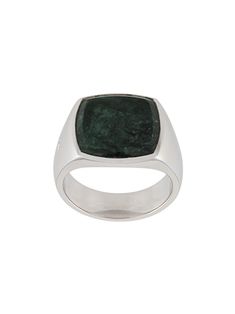 a ring with a green stone in it