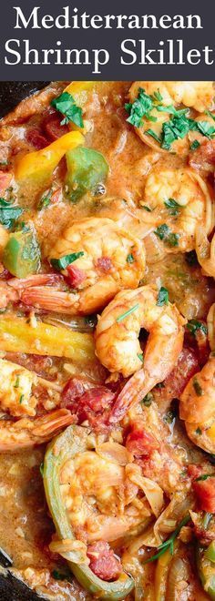 a skillet filled with shrimp and vegetables