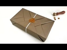 an origami envelope with a wax stamp on it