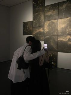 two people are taking pictures with their cell phones