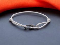 🌟 Elevate your accessory game with our Simple Bamboo Horseshoe Buckle Bracelet! 🌟 This chic and minimalist bracelet features a stylish horseshoe buckle, perfect for adding a touch of nature-inspired elegance to any outfit. 🎀 Key Features: Braided Ribbon Design: The unique braided look adds texture and charm, making it a standout piece for both men and women. Adjustable Fit: Easily customize the size for a comfortable fit, so you can wear it every day! Durable Stainless Steel: Designed for longevity, this bracelet combines style with durability, ensuring it remains a favorite in your collection. ✨ Whether you wear it solo or stack it with other bracelets, this versatile piece is perfect for any occasion--casual outings, parties, or simply adding flair to your daily wear. 🎁 A thoughtful Diy Rope Bracelet, Braided Ribbon, Bracelet Simple, Band Design, Buckle Bracelet, Charm Making, Ribbon Design, Minimalist Bracelet, Braided Bracelets