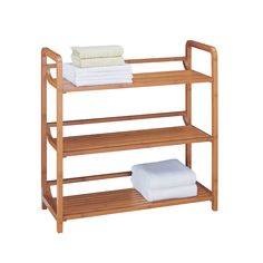 three tiered wooden shelf with folded towels on top and two white sheets stacked in the bottom