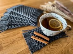 a cup of tea with cinnamon and an orange slice