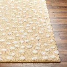 a beige rug with white spots on it