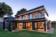 a modern house with glass walls and sliding doors