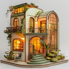 a doll house with plants and lights in the windows