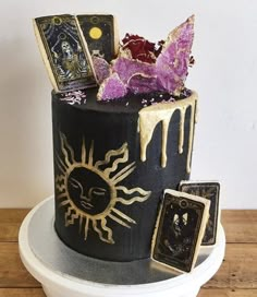 a black and gold cake with pictures on it