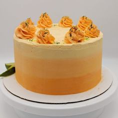 a cake with orange frosting on a white plate