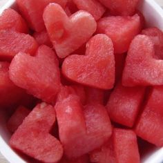 a white bowl filled with watermelon hearts