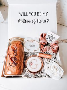 a box with some items in it and the words will you be my matron of honor?