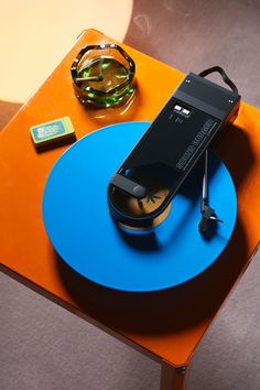 a cell phone sitting on top of a blue and orange table