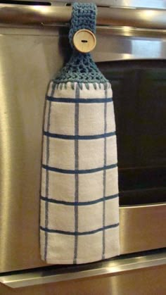 an oven mitt hanging from the side of a stove