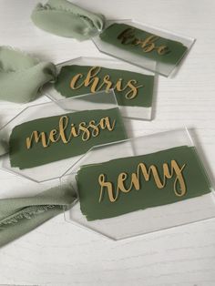 three tags with the names of different types of items in gold and green on them