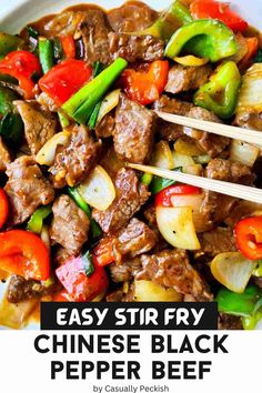 beef stir fry in a white bowl with chopsticks and peppers on the side