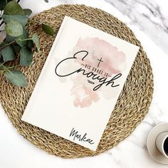 a book sitting on top of a wicker plate next to a cup of coffee