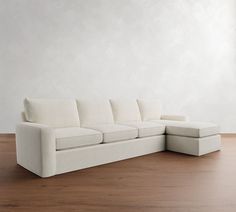 a white couch sitting on top of a wooden floor