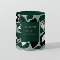 a green tea canister sitting on top of a table