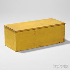 a wooden box sitting on top of a white surface