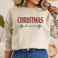 This Christmas Sweatshirt is the perfect gift idea for her, combining festive charm with cozy comfort. This cute Christmas sweatshirt makes a delightful addition to her holiday wardrobe, ensuring she stays warm and stylish throughout the season. T-Shirt Details: -Gildan 18000 Unisex Sweatshirt  -Polyester & Cotton  -Ribbed Knit Collar & Seams -No itchy Side Seams How to order? -Select the color you would like to order -Select the size you would like to order (See measurements details in photo) - Festive Long Sleeve Cotton Sweater, Festive Holiday Crew Neck Sweatshirt, Casual Christmas Sweatshirt For Festive Occasion, Casual Christmas Festive Sweatshirt, Casual Christmas Sweatshirt, Festive Long Sleeve Fall Sweatshirt, Festive Christmas Crew Neck Sweatshirt, Christmas Cotton Sweatshirt, Festive Holiday Cotton Sweater