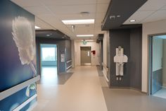 an empty hospital hallway is shown in this image